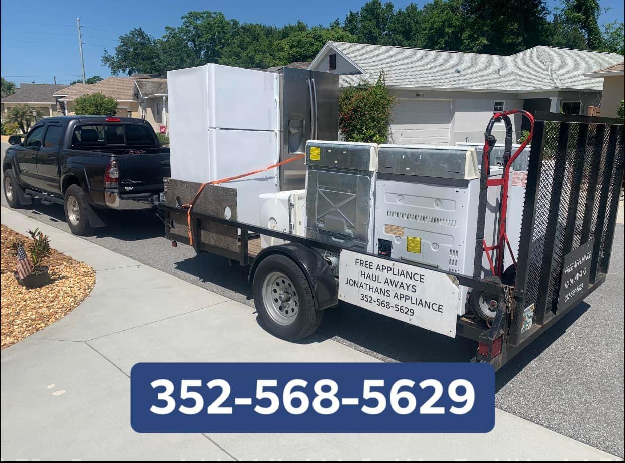 appliances being hauled away on a trailer