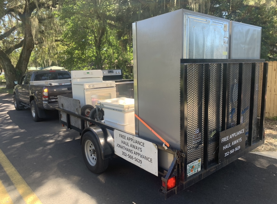 refrigerators and stoves being picked up for disposal